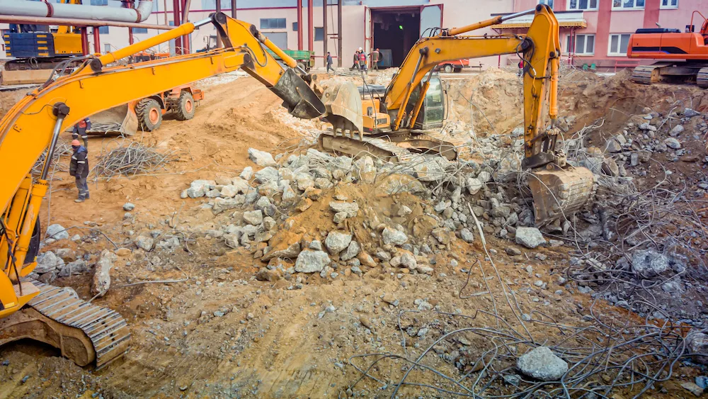 Excavators clearing an industrial demolition site